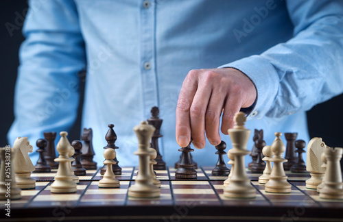 Hand of man playing chess