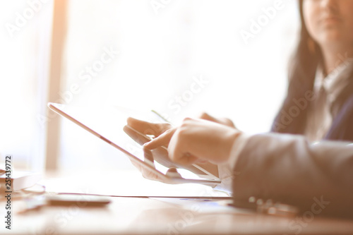 businessman clicks on the screen of a digital tablet