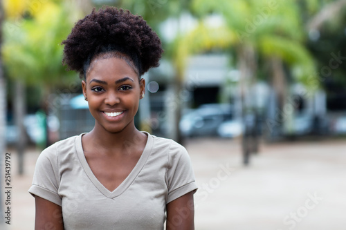 Laughing caribbean woman with afro hair