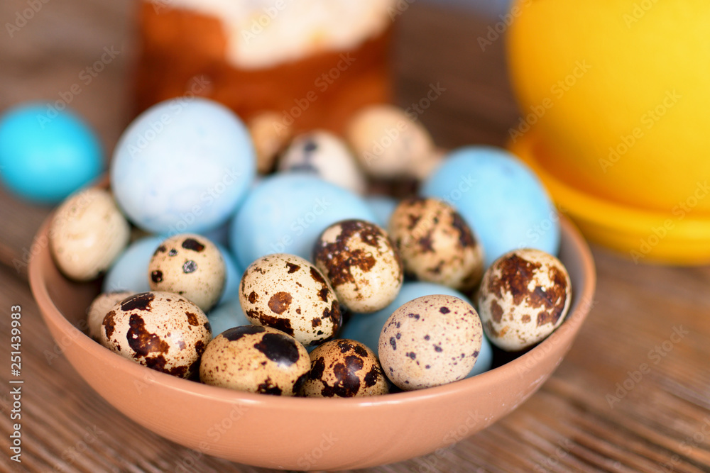 Easter painted chicken and quail eggs in clay bowl. Happy Easter.