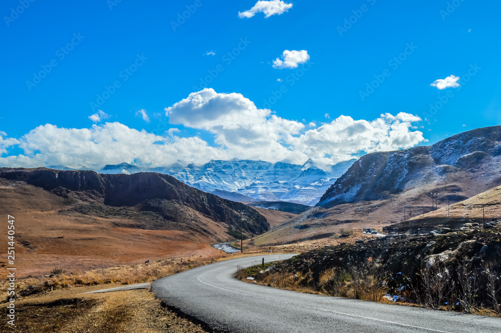 Fototapeta premium Picture perfect snow capped Drakensberg mountains and green plains in Underberg near Sani pass South Africa