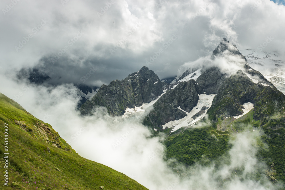 summer mountains green grass snow and stormy sky landscape summer mountains green grass snow and stormy sky landscape