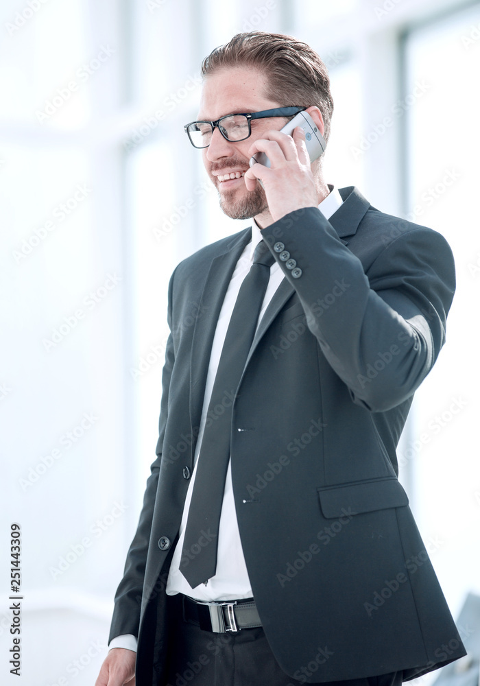 confident businessman talking on mobile phone. confident businessman talking on mobile phone.