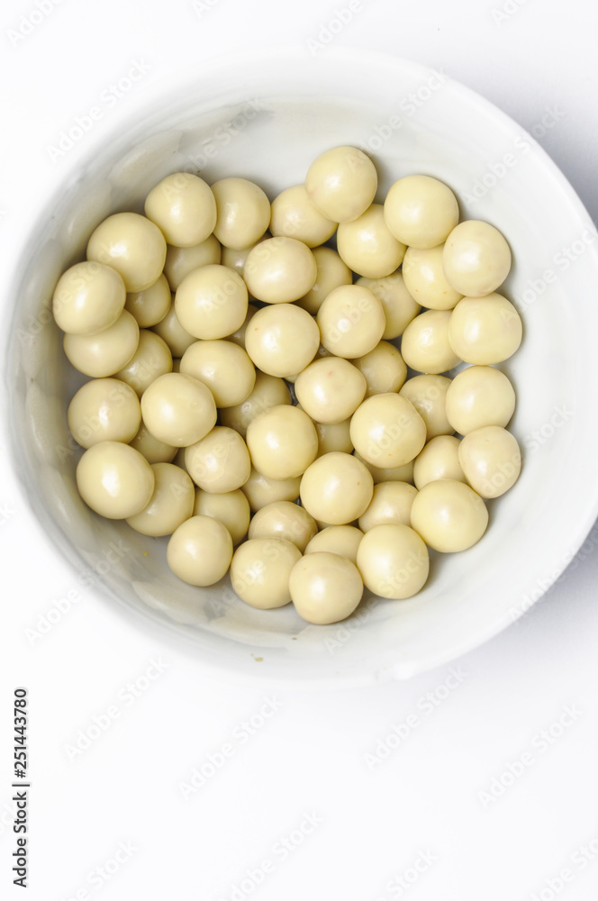 Tasty white chocolate ball in cup isolated on white background Tasty white chocolate ball in cup isolated on white background
