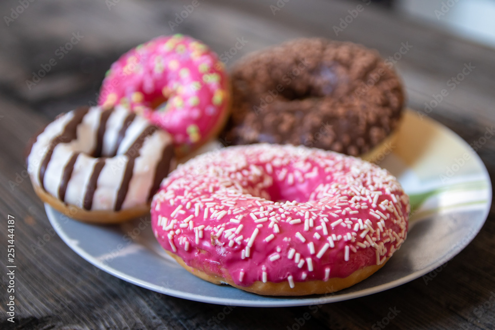 Various donuts on old wooden table. With chocolate fill and nuts, pink glazed and with stars. Various donuts on old wooden table. With chocolate fill and nuts, pink glazed and with stars.