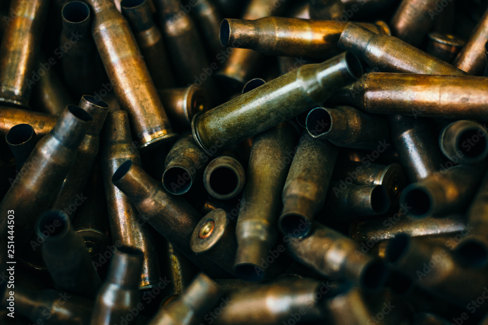 pile of used rifle cartridges 7.62 mm caliber, many empty bullet shells, assault rifle bullet shell, military background, top view pile of used rifle cartridges 7.62 mm caliber, many empty bullet shells, assault rifle bullet shell, military background, top view