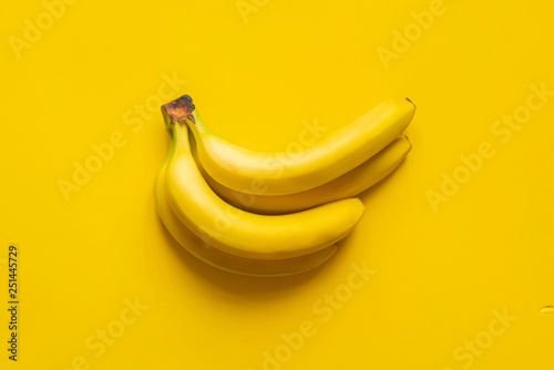 a bunch of bananas on yellow background isolated copy space design mockup b