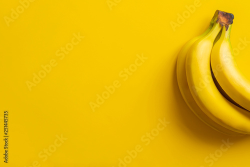 a bunch of bananas on yellow background isolated copy space design mockup b