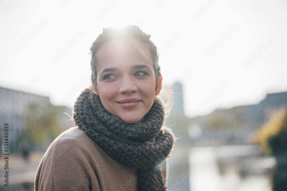 Portrait of smiling woman wearing scarf at backlight Portrait of smiling woman wearing scarf at backlight