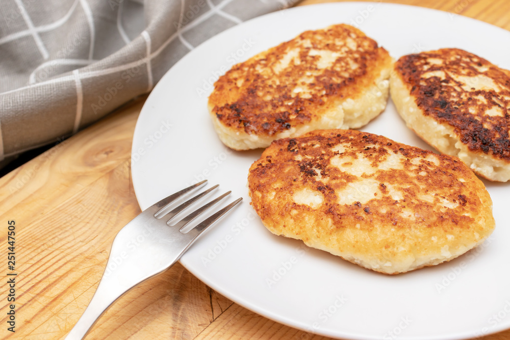 Russian syrniki or sirniki, homemade cottage cheese fritters or pancakes. breakfast with curd pankakes