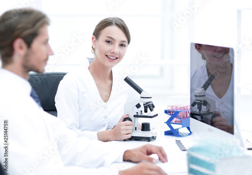 Lab expert working on a test using microscope
