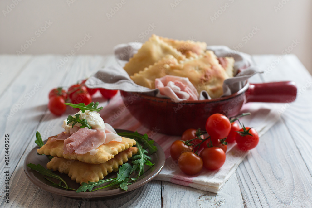 Gnocco fritto or Crescentina is a bread in Italian cuisine from the Emilia region of Italy accompanied with cheese squacquerone and prosciutto. Gnocco fritto or Crescentina is a bread in Italian cuisine from the Emilia region of Italy accompanied with cheese squacquerone and prosciutto.