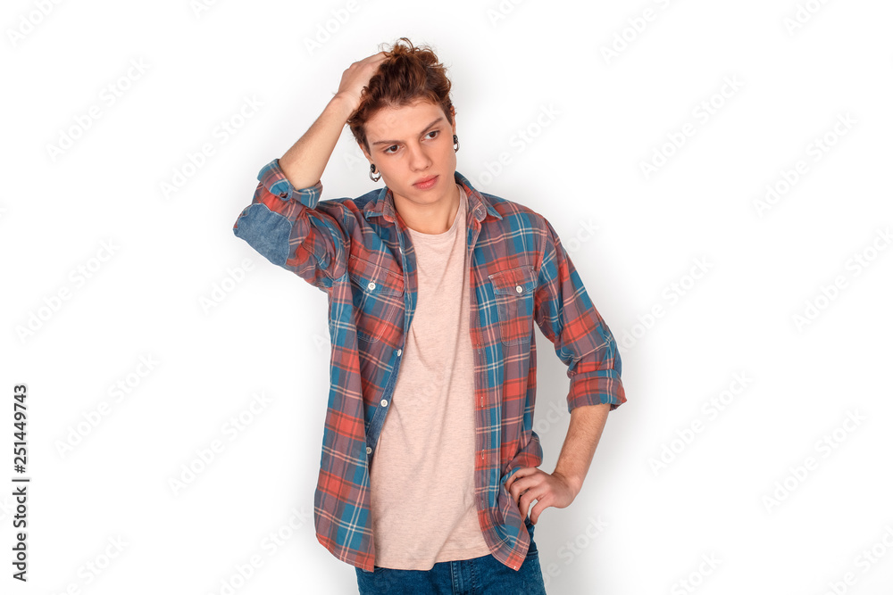 Teenager with earrings studio standing isolated on white looking aside concerned Teenager with earrings studio standing isolated on white looking aside concerned