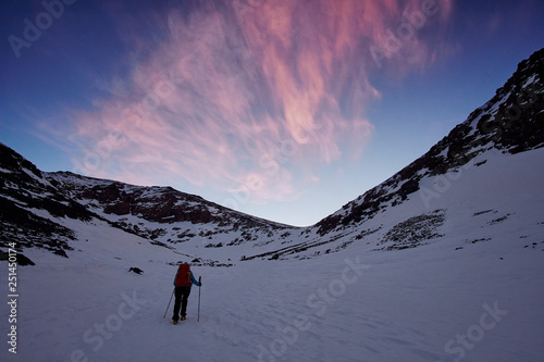 A tourist girl walking at the snowfield to the Jebel Toubkal before the sunrise in High Atlas mountains Morocco Africa © Lukas