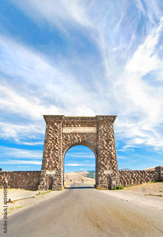 Roosevelt Arch at Gardiner, Montana.   North Entrance to Yellowstone National Park.  USA.  Under a Dramatic Cloudy sky.
