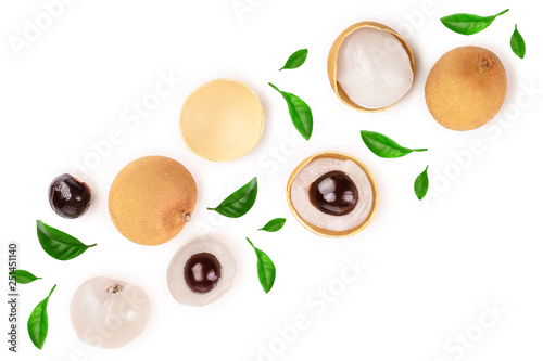 Fresh longan fruit with leaves isolated on white background. Top view. Flat lay photo