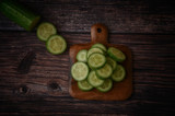 Fresh sliced cucumbers on an old wooden table. Top view, healthy food concept