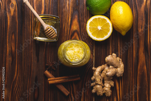 Ginger, lemon, honey, cinnamon on a dark wooden background