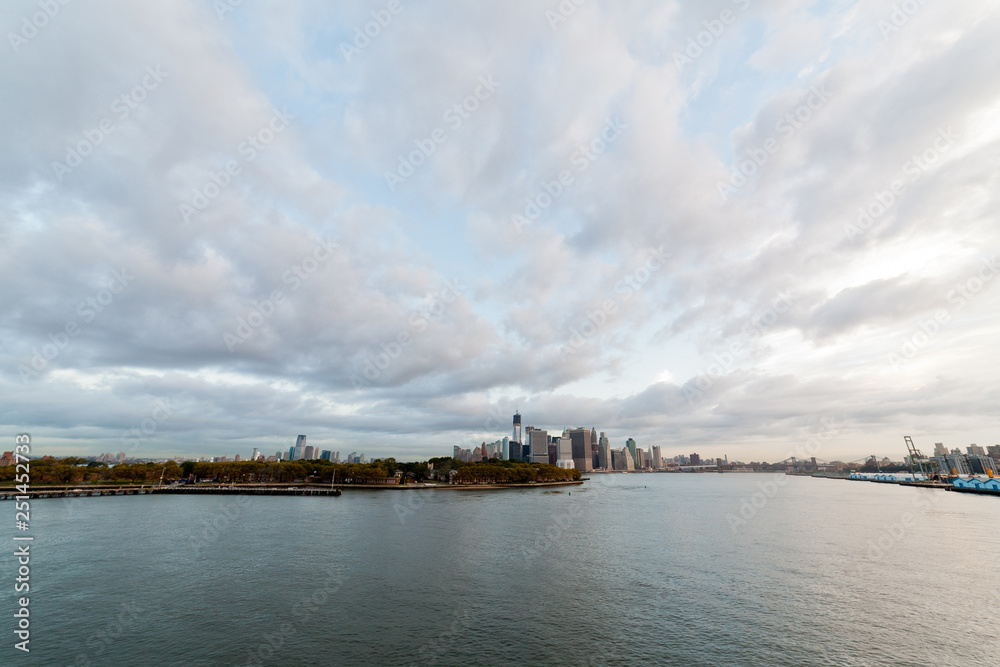 View of dramatic clouds over New York city skyline and upper Hudson River in morning from Brooklyn Cruise Terminal 