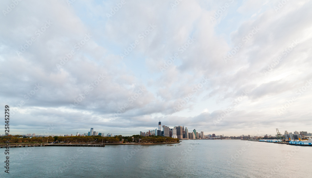 View of dramatic clouds over New York city skyline and upper Hudson River in morning from Brooklyn Cruise Terminal 