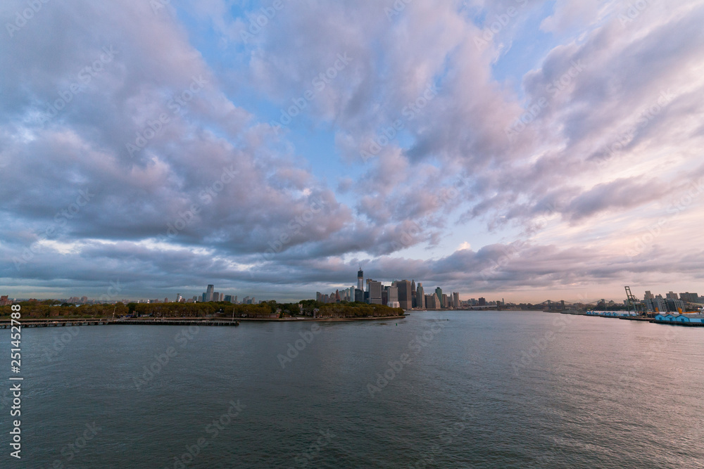 View of dramatic clouds over New York city skyline and upper Hudson River in morning from Brooklyn Cruise Terminal 