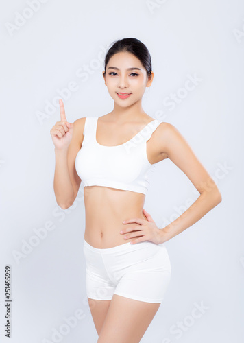 Portrait young asian woman smiling beautiful body diet with fit and finger pointing something isolated on white background, model girl weight slim with cellulite, health and wellness concept.