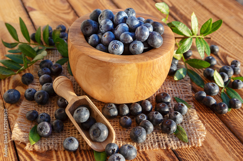 Blueberries in bowl on rustic wooden background. Close up