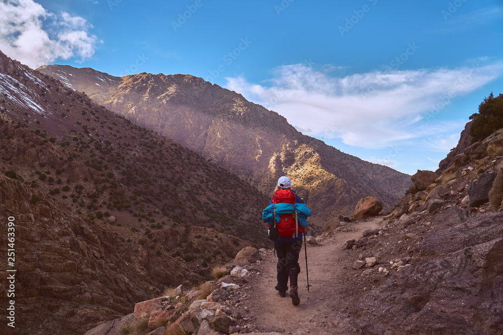 Hiker girl on the tourist path in High Atlas mountains in Jebel Toubkal region Morocco Africa