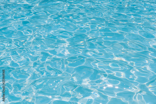 Blue water in pool for background and abstract, Ripple wave with sun reflection in swimming pool, Clean and bright purified water for healthy swimming