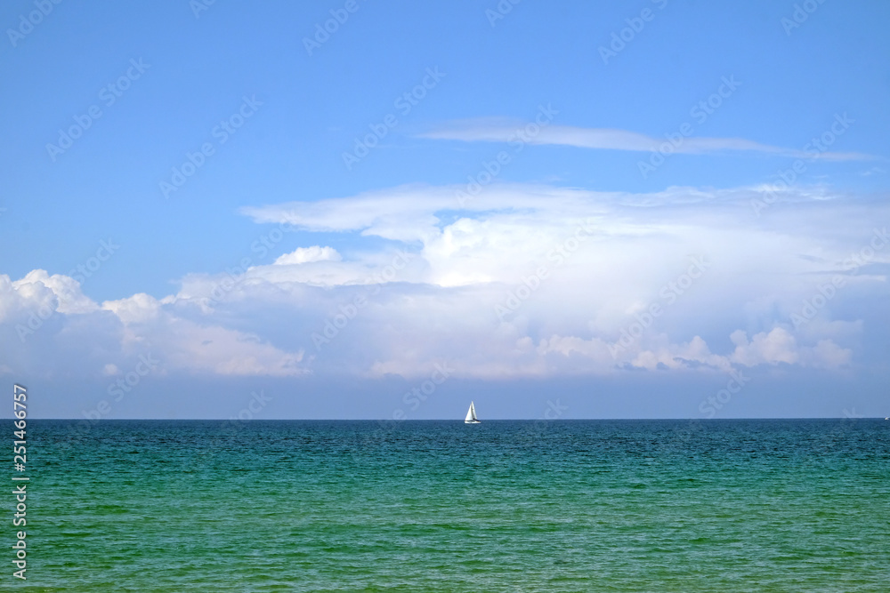 Yacht with white sails sailing on the sea