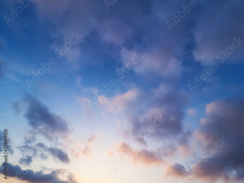 bucolic background of orange and blue sunset sky, with clouds and orton effect
