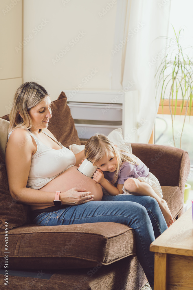 Mother mom daughter girl pregnant living room happiness
