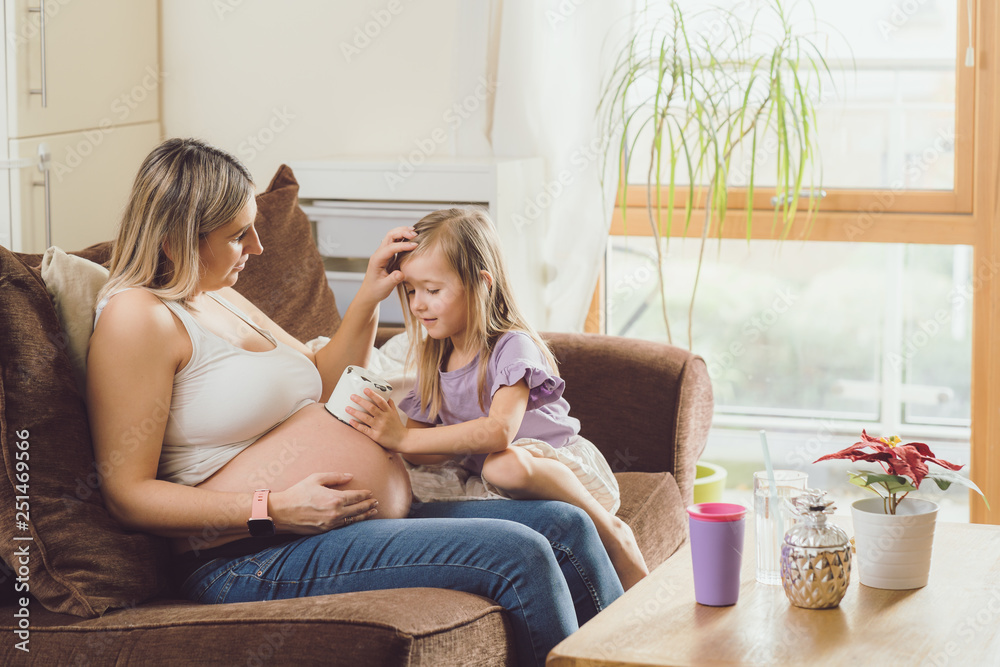 Mother mom daughter girl pregnant living room happiness