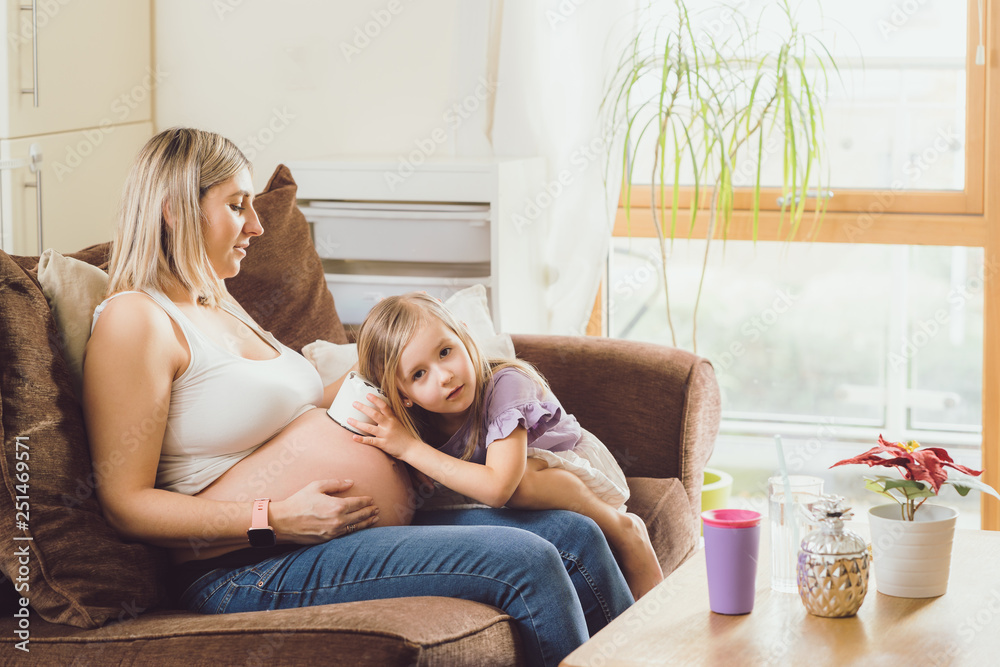 Mother mom daughter girl pregnant living room happiness