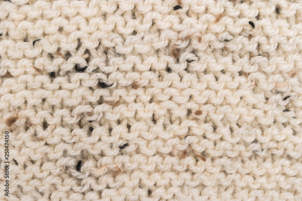 Winter Sweater Design. Bege knitting wool texture background. knitted fabric texture. Knitted jersey background with a relief pattern. Braids in knitting. Winter Sweater Design. Bege knitting wool texture background. knitted fabric texture. Knitted jersey background with a relief pattern. Braids in knitting.