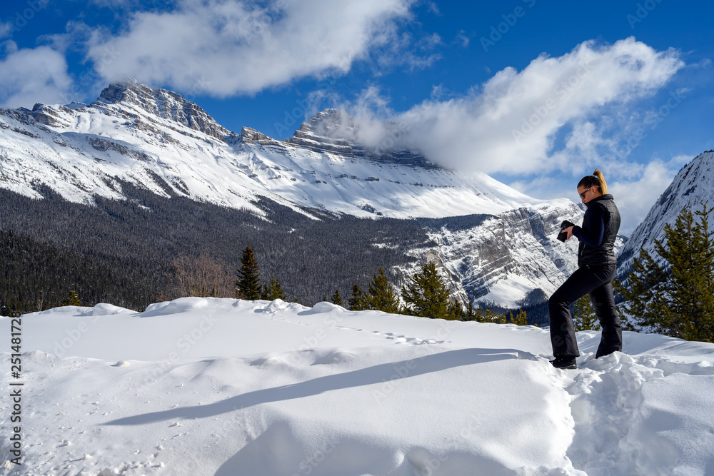 Female nature photographer taking picture of the snowy mountains at the Icefields Parkway in Jasper National, Alberta, Canada Female nature photographer taking picture of the snowy mountains at the Icefields Parkway in Jasper National, Alberta, Canada