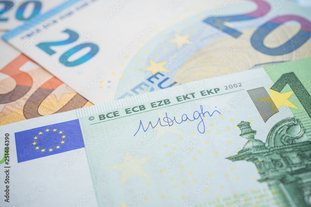 Macro shot focus on Mario Draghi's signature on money cash euro banknote background. The currency of the euro country area and institutions. Europe and world financial economic investment concept. Macro shot focus on Mario Draghi's signature on money cash euro banknote background. The currency of the euro country area and institutions. Europe and world financial economic investment concept.