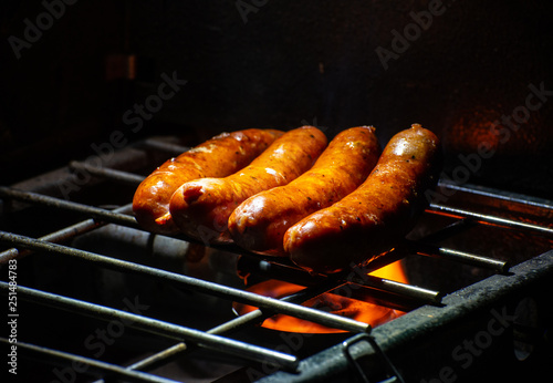 Grilled Sausages on a propane grill at an outdoor camp site