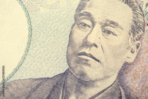 Close up macro of Fukuzawa Yukichi on 10000 Japanese yen banknote texture background. Concept of Japanese yen payment currency of Japan. Forex investment, stock market or asia global financial economy