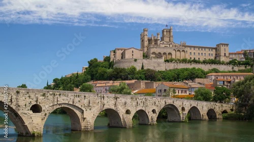 Amazing time-lapse video of old bridge and Saint Nazaire cathedral on the Orb river in Beziers, France. photo