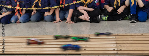 Fényképezés Boys watching wooden pinewood car race