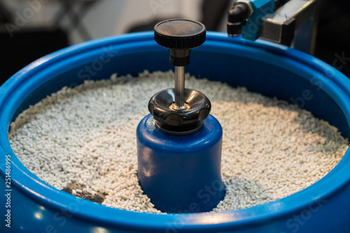 Plastic granules in a blue industial machine
