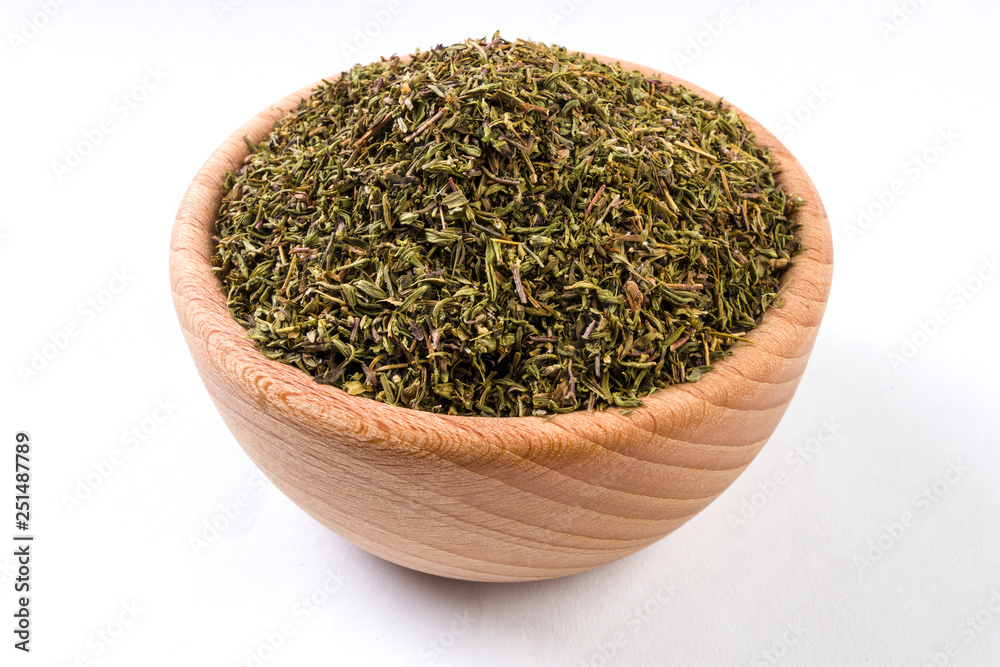 thyme herb in wooden bowl isolated on white background.