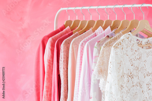 Pink women clothes hanging on rack