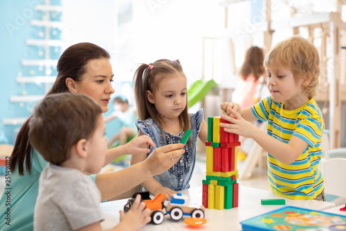 Little kids build block toys at home or daycare. Kids playing with color blocks. Educational toys for preschool and kindergarten children. photo