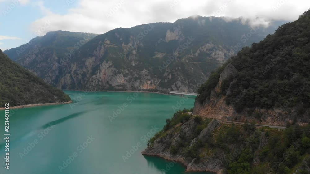 Aerial Montenegro Border Mountain and Lake Dam June 2018 Sunny Day Mavic Air Aerial video of a blue lake with a large dam on the border of Bosnia and Montenegro. Aerial Montenegro Border Mountain and Lake Dam June 2018 Sunny Day Mavic Air Aerial video of a blue lake with a large dam on the border of Bosnia and Montenegro.