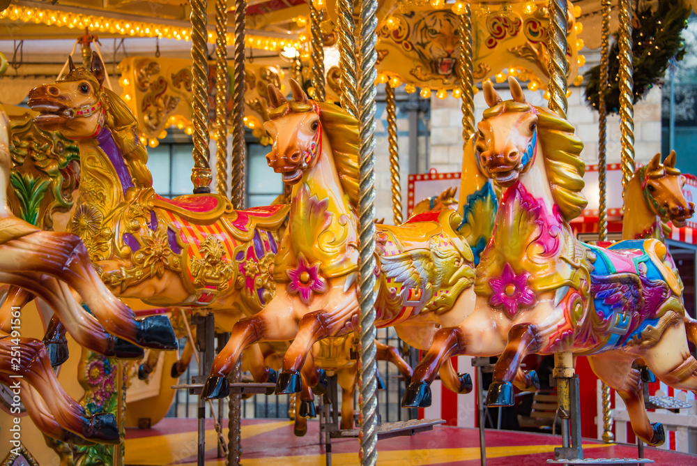 Colorful horse carousel at an amusement park.