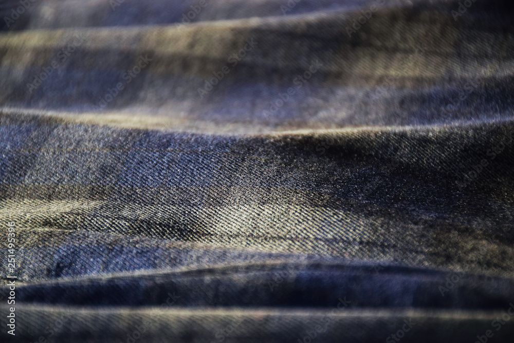 Abstract close up photo of blue and green tartan material in soft sunlight