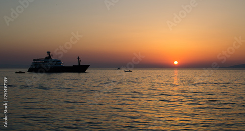 Sun setting over the sea with a yacht on the foreground © Rafael