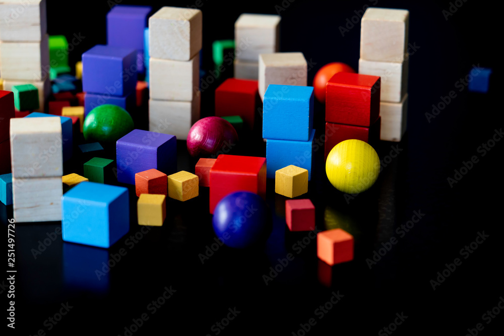 Obraz premium Toy wood blocks for Children to play with on black background